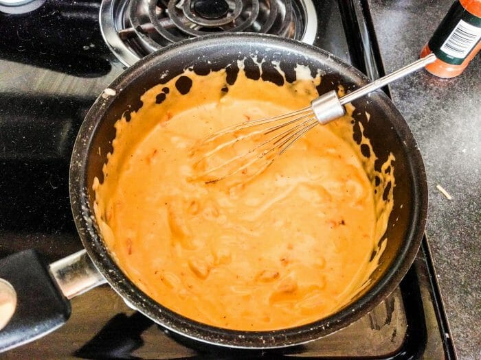 Beer Cheese Gravy being made in a saucepan