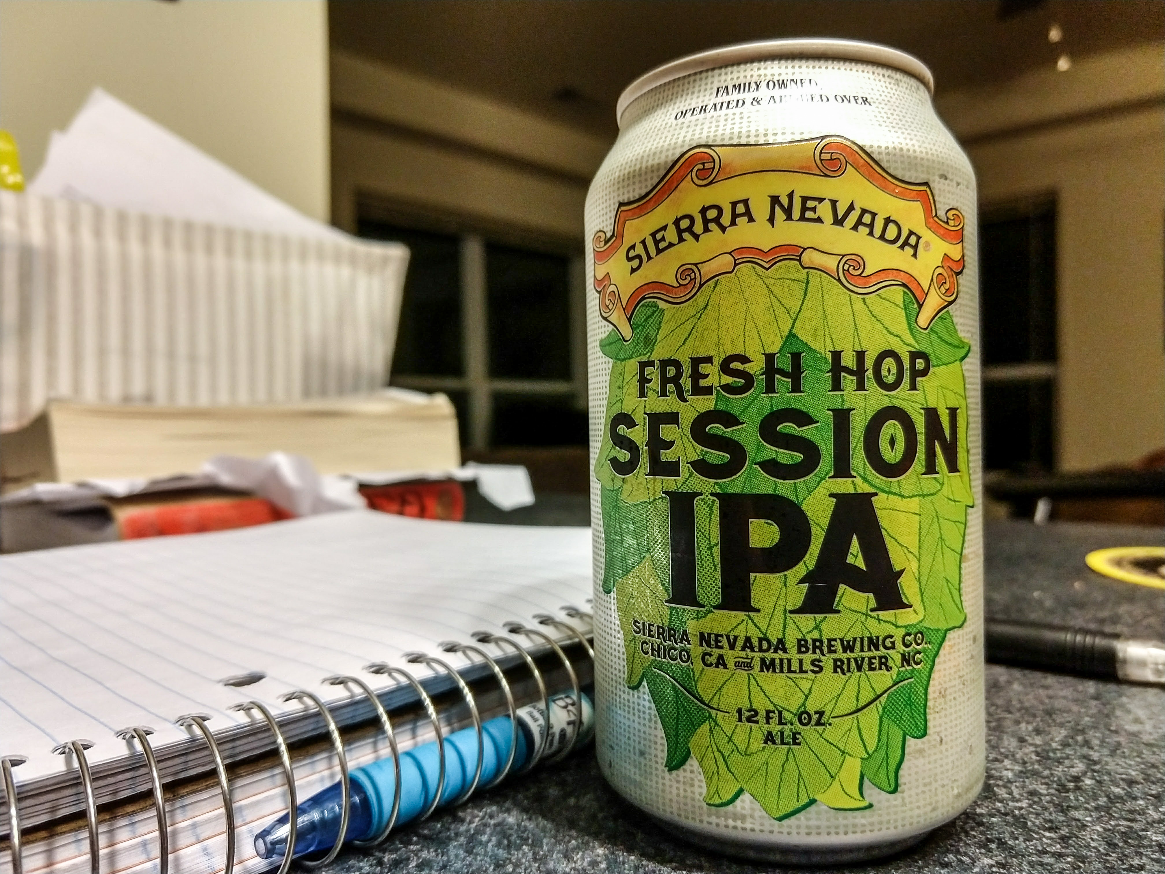 A can of Sierra Nevadas fresh hop session beer next to a notebook.