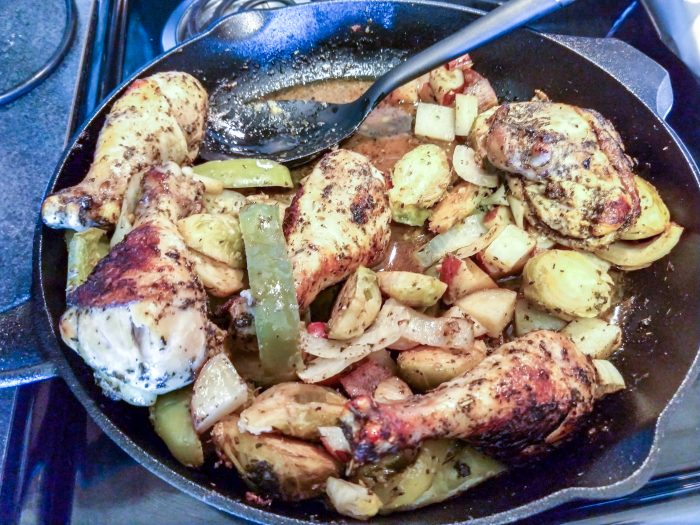 Eating garlic basil chicken from a cast iron skillet